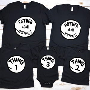 May include: Black family matching t-shirts and a onesie. The shirts have white circles with the phrases "FATHER of all THINGS", "MOTHER of all THINGS", "THING 1", "THING 2", and "THING 3". The onesie has snaps at the bottom.