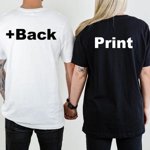 May include: Two short-sleeved t-shirts, one white and one black, are shown from the back. The white shirt has the text "+Back" printed in bold black letters. The black shirt has the word "Print" printed in bold white letters.