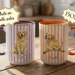 May include: Two 15 oz. ceramic mugs with dog illustrations. One mug has a purple handle and rim with a sitting golden retriever on a striped background. The other mug has an orange handle and rim with a dog holding a bone.