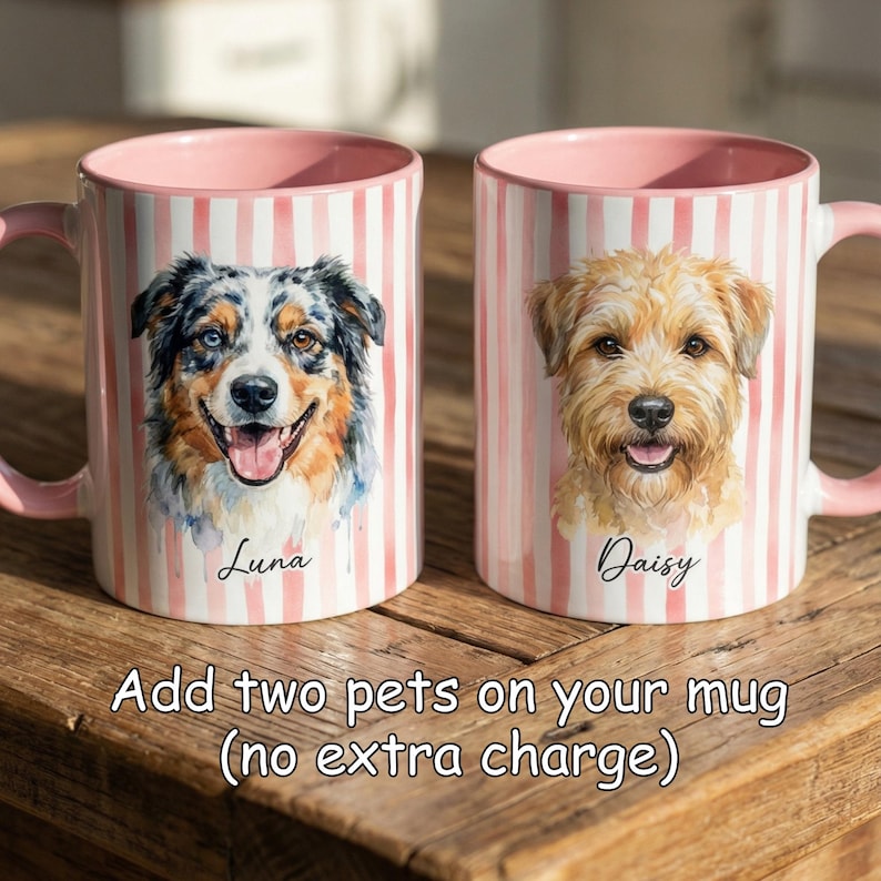 May include: Two ceramic mugs with pink interiors and handles, featuring watercolor portraits of dogs. One mug has a blue, brown, and white dog named Luna, the other has a tan dog named Daisy. Both mugs have pink and white striped exteriors.