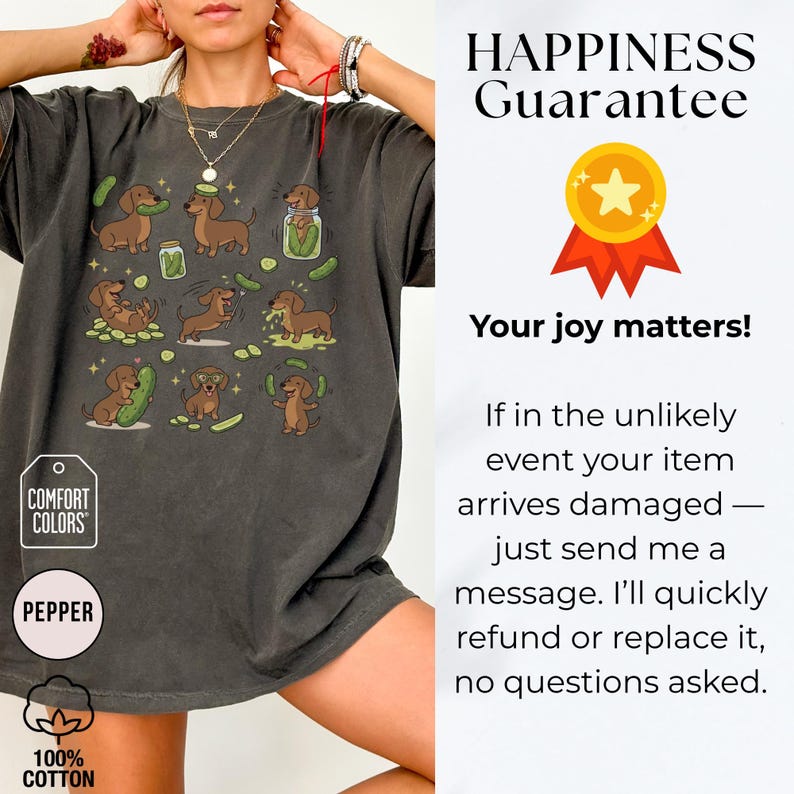 May include: Dark grey t-shirt featuring a playful design of dachshunds and pickles. The graphic includes various poses of the dogs with pickles. The shirt has the text "COMFORT COLORS" and "PEPPER" on it. Made of 100% cotton.