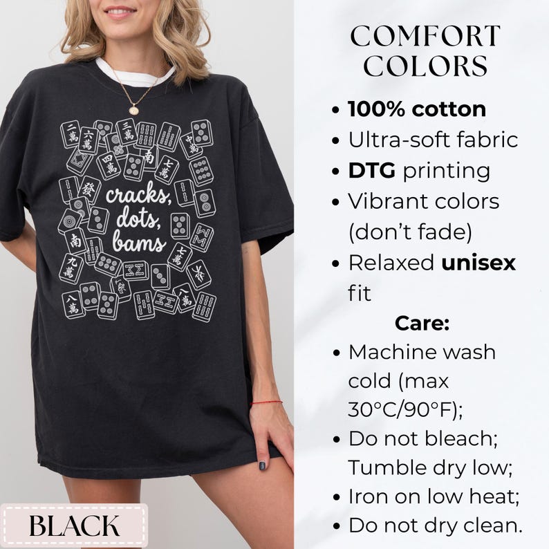 May include: Black t-shirt with a white graphic of Mahjong tiles and the words "cracks, dots, bams." The shirt also has the word "BLACK" at the bottom. The shirt is made of 100% cotton and has a relaxed unisex fit.