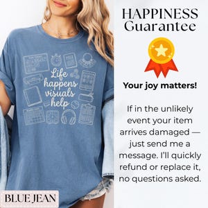 May include: A blue jean-colored t-shirt with the phrase "Life happens visuals help" and various visual aid icons printed in white. The shirt also features the text "BLUE JEAN".