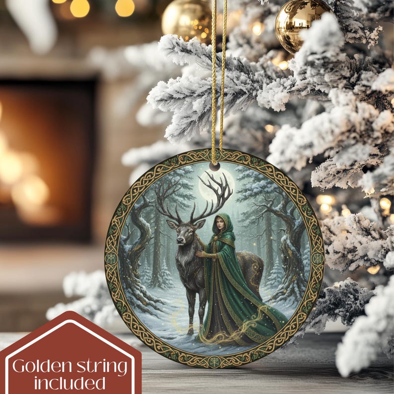 May include: Round Christmas ornament with a winter forest scene. The ornament features a woman in a green cloak with a deer, set against a snowy forest backdrop. The ornament has a gold border and a golden string for hanging. The text "Golden string included" is in the lower left corner.