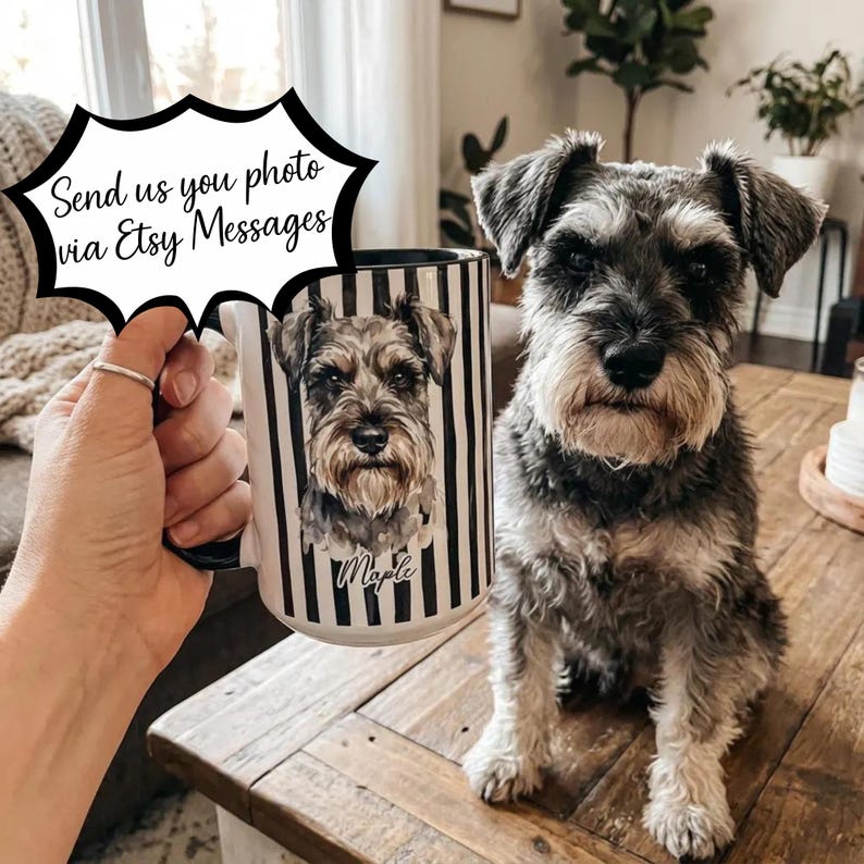 May include: A white ceramic mug with a black interior and handle, featuring a portrait of a Schnauzer dog with the name "Maple" below. The mug has black and white vertical stripes. The text "Send us you photo via Etsy Messages" is in a speech bubble.