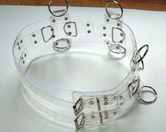 Cintura BDSM trasparente, extra larga (10,0 cm), cintura a 5 anelli, 6 O-ring. La cintura è trasparente e cristallina.