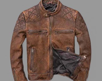 May include: A brown leather jacket with a quilted design on the shoulders and sleeves. The jacket has a zipper closure and multiple pockets.
