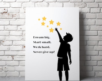 May include: White canvas art print featuring a black silhouette of a child reaching for yellow stars. The text reads "Dream big. Start small. Work hard. Never give up!" The artwork is leaning against a white brick wall.