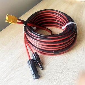 May include: A coiled black and red wire with yellow connectors on one end and black connectors on the other end.