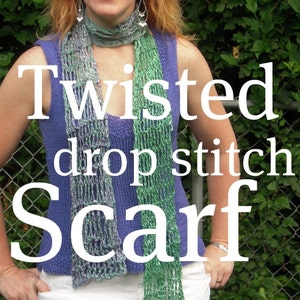 May include: A knitted scarf with a twisted drop stitch design. The scarf features shades of green, gray, and purple. The text "Twisted drop stitch Scarf" is displayed in white. The scarf is worn over a blue top.
