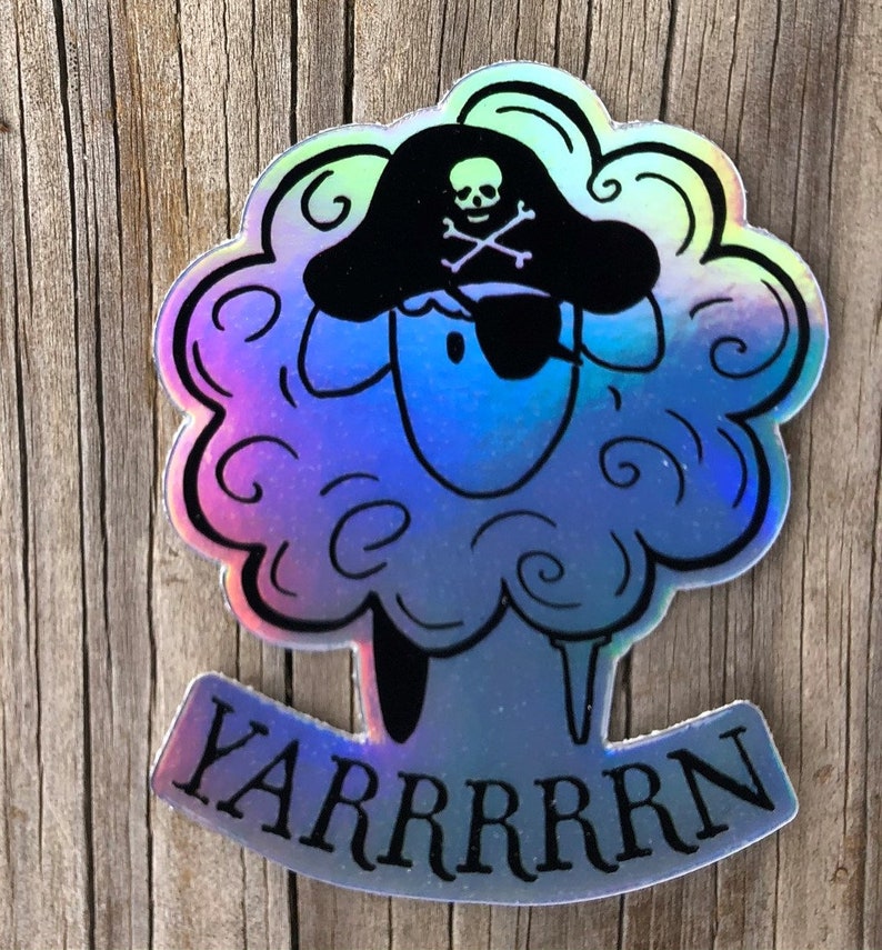 May include: Holographic sticker featuring a sheep wearing a pirate hat and eye patch. The sheep has a fluffy, cloud-like appearance with a blue and purple gradient. The word "YARRRRRN" is written below the sheep in a curved banner.
