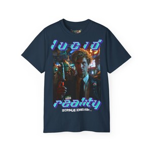 May include: A navy blue t-shirt with a graphic print of a man in a dark jacket and tie. The graphic has the text "lucid reality" with the words "something tells me..." below it.