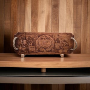 May include: A wooden serving tray with rope handles features a vintage design of wine bottles, grapes, and the word "SLEEK".