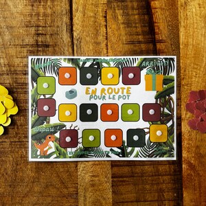 Peut inclure: Un plateau de jeu coloré sur le thème de la jungle. Le plateau comporte un chemin avec 18 cases, chacune d'une couleur différente. Le jeu s'appelle "En Route Pour Le Pot".