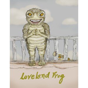 May include: A cartoon illustration of a green frog with a wide smile, standing on a wooden railing. The frog has large, yellow eyes and is wearing a white shirt. The text "Love Land Frog" is written in green below the frog.