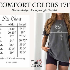 May include: A dark gray Comfort Colors 1717 garment-dyed heavyweight t-shirt. The image includes a size chart with measurements in inches for sizes S to 4XL. The model is wearing a size Large. The Tee Markt logo is visible.