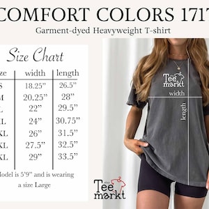 May include: A dark gray Comfort Colors 1717 garment-dyed heavyweight t-shirt. The image includes a size chart with measurements in inches for sizes S to 4XL. The model is wearing a size Large. The Tee Markt logo is visible.