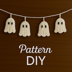 May include: A string of four handmade, off-white crochet ghosts with black eyes, suspended from a white string. The ghosts are set against a dark brown wooden background. The words "Pattern DIY" are displayed in white script.