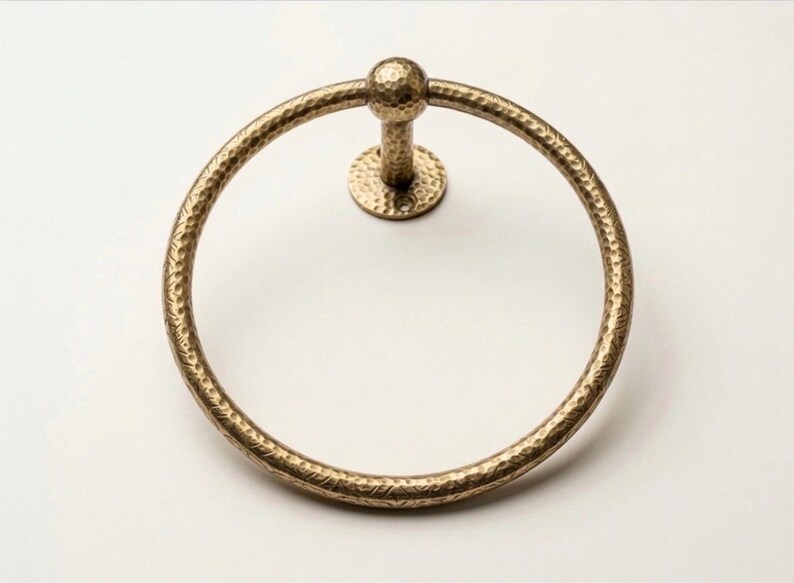 Measurement guide for hammered brass towel holder and toilet ring in inches, highlighting the handcrafted texture and mounting sizes