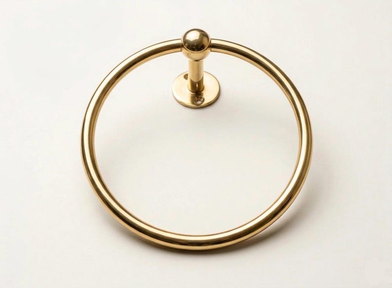 Artisan-made polished brass hand towel ring, featuring a smooth surface and durable wall mount, crafted by skilled Moroccan metalsmiths