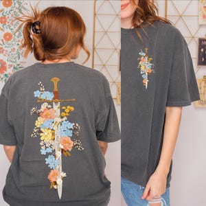 Lifestyle look at Floral Sword Shirt Front Back Print Cottagecore Wildflower Graphic Tee Women on Comfort Colors 1717. Soft vintage wash, oversized unisex fit, garment-dyed cotton gift tee.