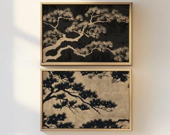 May include: Two framed art prints featuring stylized black and beige pine tree branches. The top print has a black background, while the bottom print has a beige background. Both prints are in light brown wooden frames.