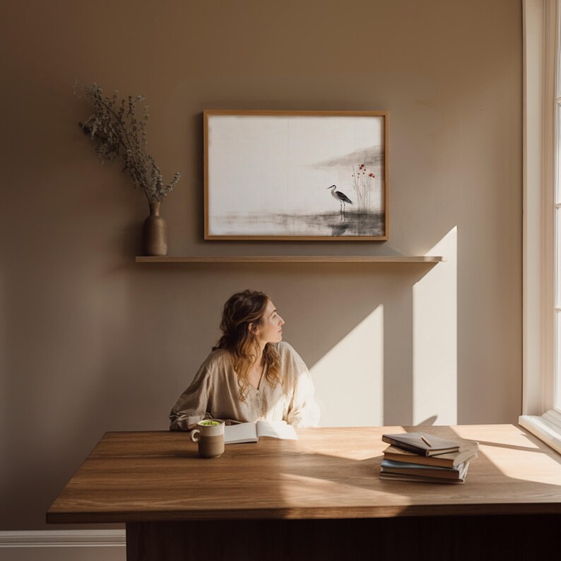 Tranquil crane wall art in Japandi aesthetic — sumi-e ink painting with earthy hues and subtle red flowers. This digital download embodies Wabi Sabi philosophy, bringing peace, balance, and elegance to Scandinavian or zen-inspired interiors.