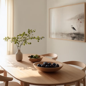 Digital Japandi wall art showing a crane standing gracefully beside tranquil water. The soft red floral accents and earthy ink tones bring warmth and calm to Wabi Sabi-inspired decor. A perfect printable artwork for peaceful, modern interiors.