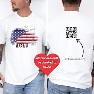 May include: White t-shirt with a watercolor design of the Statue of Liberty and the words "I Support ACLU" on the front. The back of the shirt has a QR code and the text "action.aclu.org".