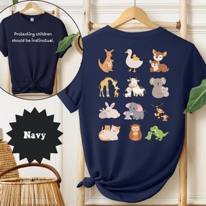 May include: Navy blue t-shirt featuring a knot detail and the text "Protecting children should be instinctual." The back of the shirt displays various animal illustrations, including a kangaroo, giraffe, and koala, each with their young.