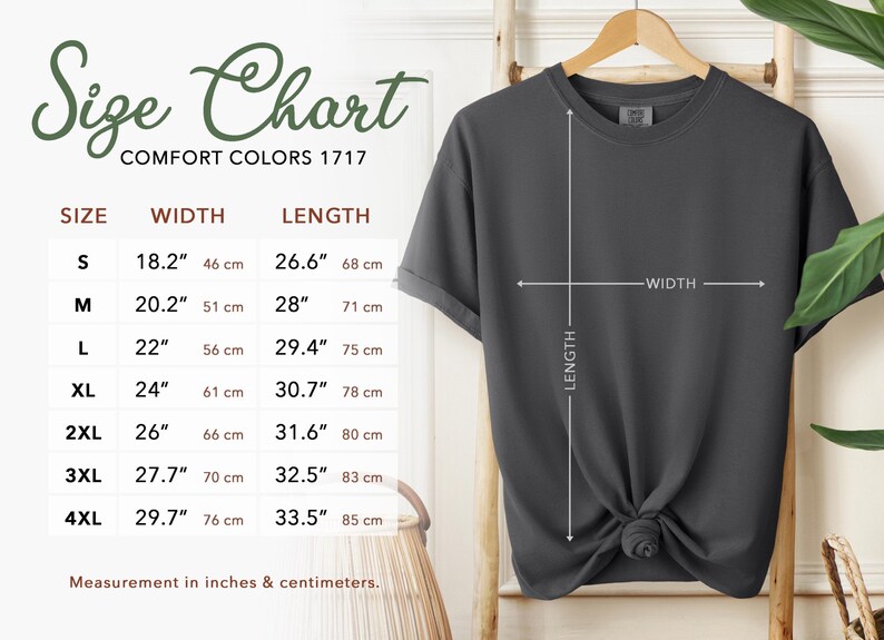 May include: A dark gray t-shirt displayed on a wooden hanger, with a size chart to the left. The size chart shows measurements in inches and centimeters for width and length, ranging from size S to 4XL.