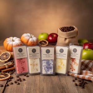 May include: Five rectangular plastic containers of wax melts, each with a label reading Apple Cinnamon, Sweet Vanilla Caramel, Blueberry Cheesecake, My Grandma's Kitchen, or Apple Cider Donut. The melts are pink, white, purple, yellow, and white.