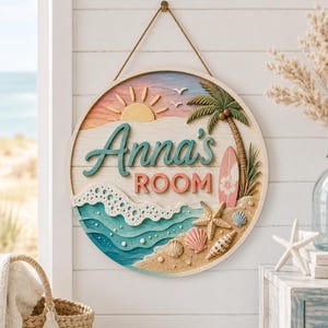 May include: A circular wooden wall sign featuring a beach scene with a sun, palm tree, surfboard, and seashells. The text "Anna's ROOM" is displayed in the centre. The sign has a layered design with blue ocean waves, sandy beach textures, and a rope hanger.