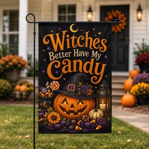 May include: A black rectangular garden flag featuring the orange text Witches Better Have My Candy, a jack-o'-lantern wearing a witch hat, a lantern with a lit candle, a cauldron filled with candy, and various colorful autumn flowers.