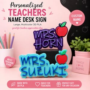 May include: Two 3D printed desk signs made of multicolor PLA, one purple with the text MRS. HORN and one light blue with the text MRS. SUZUKI. Each sign features a red apple icon with a green leaf. The signs are displayed on a pink surface.