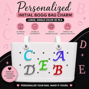 May include: A white tote bag featuring five colourful 3D printed letter charms attached to its surface. The letters C, A, D, E, and B are displayed in cyan, blue, grey, green, and red. Text includes Personalised Initial Bogg Bag Charm.
