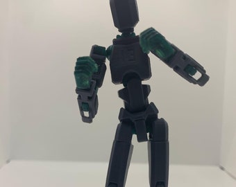 Op de afbeelding: Een grijs gearticuleerd actiefiguur met groene gewrichten. De figuur is geposeerd in een dynamische houding met zijn armen omhoog.