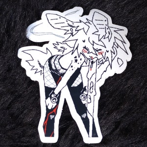 May include: Black and white sticker of a cartoon character with wings, wearing a black outfit and a halo. The character has red markings on its face and is holding a microphone.