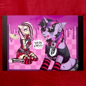 May include: Illustration of two cartoon ponies in emo attire. One pony has pink and black hair and is kneeling. The other pony has purple and black hair and is standing. The text "WE'RE EMO!!!" is in a speech bubble.