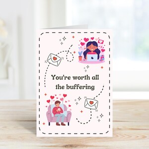 May include: A pink and white Valentine's Day card with a cartoon couple on a video call. The card says "You're worth all the buffering".