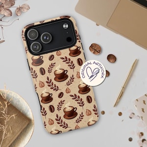 May include: A phone case with a coffee-themed pattern. The design features brown coffee cups, coffee beans, and leaves on a tan background. The case has a black camera module and a round sticker that says "Original Artwork".