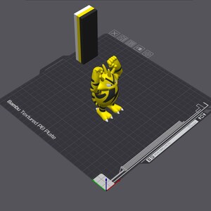 May include: A 3D-printed yellow and black cartoon character with its arms raised, standing on a black grid. A rectangular block with yellow, black, and white stripes stands behind the character. The base reads "Bambu Textured PEI Plate".