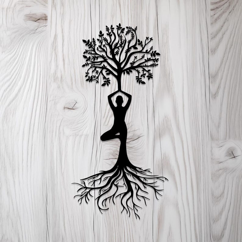 May include: A black silhouette of a person in a yoga pose with a tree growing out of their head and roots extending down from their feet. The image is on a white wood background.