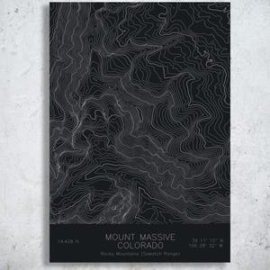 May include: A black and white topographic map print of Mount Massive in Colorado. The design features intricate white contour lines on a dark background with text at the bottom reading Mount Massive Colorado, 14,428 ft, and coordinates.