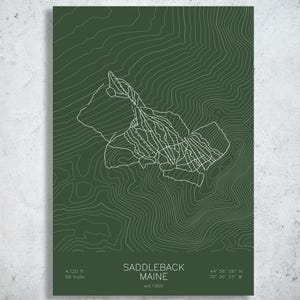 May include: A dark green poster featuring a white topographic map of Saddleback Maine with ski trail lines. The text reads Saddleback Maine, est 1960, 4,120 ft, 68 trails, and the coordinates 44 56 06 N, 70 30 33 W in white sans-serif font.