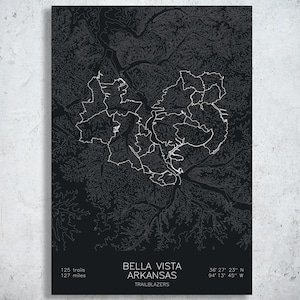 May include: A black and white map print of Bella Vista, Arkansas, with the text "125 trails, 127 miles". The print includes the coordinates 36° 27' 23" N, 94° 13' 45" W and the word "TRAILBLAZERS".
