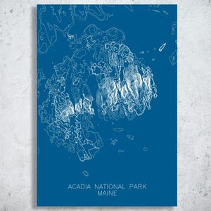 May include: A blue print of Acadia National Park in Maine. The white line art depicts the park's topography. The text "ACADIA NATIONAL PARK MAINE" is printed at the bottom of the print.