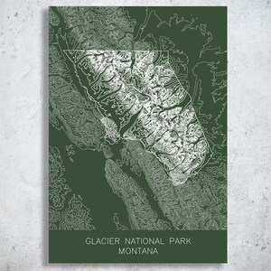 May include: A dark green print of Glacier National Park in Montana, featuring a detailed topographical map in white. The park's name and state are printed in white at the bottom of the print. The map is enclosed in a white outline.