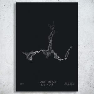May include: A black rectangular print featuring a white topographic map of Lake Mead. The text reads Lake Mead NV / AZ, 532 ft, and the coordinates 36 09 00 N 114 25 12 W. The design uses thin white lines to outline the water body shape.
