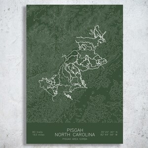 May include: A dark green topographic map print of Pisgah, North Carolina, featuring white contour lines and trail paths. The text reads: PISGAH NORTH CAROLINA, 80 trails, 163 miles, 35 20 40 N, 82 44 56 W, and PISGAH AREA SORBA.
